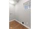 Empty Laundry room with light wood floor, window, and utility hookups at 3331 Graceland Ave, Indianapolis, IN 46208