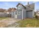 Back of house features modern gray siding, newer roof, and access to small concrete patio at 3331 Graceland Ave, Indianapolis, IN 46208
