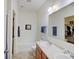 Well-lit bathroom with double sink vanity, large mirror, and a combined shower and bathtub with a closet view at 3480 Limelight Ln, Whitestown, IN 46075