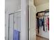 Bright bathroom with a glass-enclosed shower and access to an organized closet with clothing and storage at 3480 Limelight Ln, Whitestown, IN 46075