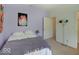 A well-lit bedroom features a lilac painted wall, plush carpet, and quirky artwork above a neatly made bed at 3480 Limelight Ln, Whitestown, IN 46075