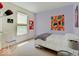 Bright bedroom featuring neutral carpet, a large window and an amusing poster collection on lilac painted walls at 3480 Limelight Ln, Whitestown, IN 46075
