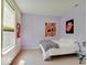 Cozy bedroom with light purple walls, carpeted floors, and a large window offering natural light at 3480 Limelight Ln, Whitestown, IN 46075
