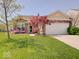Charming single-story home boasts a brick and siding facade with a well-manicured lawn and attached two-car garage at 3480 Limelight Ln, Whitestown, IN 46075