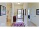 Bright foyer featuring a decorative rug, complemented by artwork and views into the dining area and beyond at 3480 Limelight Ln, Whitestown, IN 46075