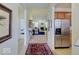 Open hallway showcasing a view into the living area with stainless steel refrigerator to the side at 3480 Limelight Ln, Whitestown, IN 46075