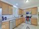 Well-lit kitchen with wood cabinets, stainless steel appliances, and ample counter space for meal preparation at 3480 Limelight Ln, Whitestown, IN 46075