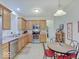 Bright kitchen featuring wooden cabinetry, stainless steel appliances, and a cozy dining area with a wine rack at 3480 Limelight Ln, Whitestown, IN 46075