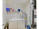 Functional laundry room with modern washer and dryer, shelving, and utility equipment for efficient home maintenance at 3480 Limelight Ln, Whitestown, IN 46075