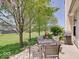 Inviting patio with outdoor seating, grill, and views of the mature tree-lined yard at 3480 Limelight Ln, Whitestown, IN 46075