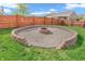 Backyard fire pit area with decorative gravel base and low retaining wall at 401 Shadetree Ln, Sheridan, IN 46069