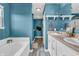 Bathroom with blue walls, double vanity, with bathtub and separate shower at 401 Shadetree Ln, Sheridan, IN 46069