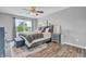 Bedroom with window view and natural light, ceiling fan, and wooden floor at 401 Shadetree Ln, Sheridan, IN 46069
