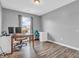 Well-lit room with wood floors features a window and two desks, ideal as a home office space at 401 Shadetree Ln, Sheridan, IN 46069
