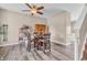 Cozy dining area featuring a wooden table, four chairs, and a modern ceiling fan at 401 Shadetree Ln, Sheridan, IN 46069
