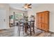 Bright dining area with wood floors, a hutch, and a large window with backyard view at 401 Shadetree Ln, Sheridan, IN 46069