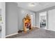 Hallway with neutral walls and carpet, leading to other rooms with natural lighting throughout at 401 Shadetree Ln, Sheridan, IN 46069