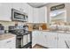 Functional kitchen with white cabinets, modern appliances, and ample counter space at 401 Shadetree Ln, Sheridan, IN 46069
