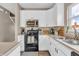 Bright kitchen features white cabinets, stainless steel appliances, and modern finishes at 401 Shadetree Ln, Sheridan, IN 46069