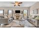 Spacious living room with ample seating, natural light, and a stylish ceiling fan at 401 Shadetree Ln, Sheridan, IN 46069