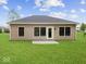 Backyard with a green lawn and tan house with black trim at 403 Fox Ridge Ct, Shelbyville, IN 46176