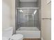 This bathroom includes a gray subway tile shower with glass door and a white toilet at 403 Fox Ridge Ct, Shelbyville, IN 46176