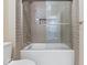 Gray subway tile shower with glass door, white toilet, and modern hardware at 403 Fox Ridge Ct, Shelbyville, IN 46176