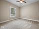 A cozy empty bedroom with carpet, neutral paint, and a window at 403 Fox Ridge Ct, Shelbyville, IN 46176