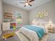 A cozy bedroom has toys, a bed, a striped rug, and a ceiling fan at 403 Fox Ridge Ct, Shelbyville, IN 46176