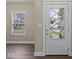Bright entryway featuring a decorative glass door and hardwood flooring at 403 Fox Ridge Ct, Shelbyville, IN 46176