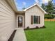 Inviting front entrance with a decorative glass door and manicured landscaping at 403 Fox Ridge Ct, Shelbyville, IN 46176