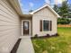 Inviting front entrance with a decorative glass door and manicured landscaping at 403 Fox Ridge Ct, Shelbyville, IN 46176