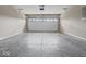 Spacious garage with concrete floor and white garage door with windows at 403 Fox Ridge Ct, Shelbyville, IN 46176