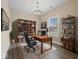An office with a large bookshelf, a desk with two chairs, and a window with natural light, creating a productive atmosphere at 403 Fox Ridge Ct, Shelbyville, IN 46176