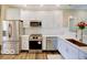 Modern kitchen with stainless steel appliances, white cabinets, and a stylish backsplash at 403 Fox Ridge Ct, Shelbyville, IN 46176