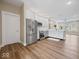 Open-concept kitchen with stainless steel appliances and hardwood floors at 403 Fox Ridge Ct, Shelbyville, IN 46176