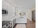 Open-concept kitchen with stainless steel appliances and hardwood floors at 403 Fox Ridge Ct, Shelbyville, IN 46176
