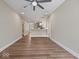 An open-concept living room with hardwood floors, a breakfast bar, and a view into the kitchen and other rooms at 403 Fox Ridge Ct, Shelbyville, IN 46176