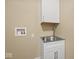 White utility sink, cabinet and upper cabinet in utility room with stainless steel sink at 403 Fox Ridge Ct, Shelbyville, IN 46176