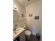 Bathroom with a sink, toilet, mirror, and simple decor at 4402 Mountbatten Ct, Indianapolis, IN 46254