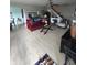 Open living room featuring a staircase, ceiling fan, and a comfortable seating area with a red sofa at 4402 Mountbatten Ct, Indianapolis, IN 46254