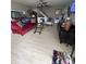 Bright living room with ceiling fan, stairs, and red sofa, creating a cozy and inviting space at 4402 Mountbatten Ct, Indianapolis, IN 46254