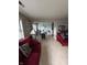 Inviting living room with a red sofa, light-filled with an open floor plan leading into the dining area at 4402 Mountbatten Ct, Indianapolis, IN 46254
