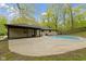 Spacious backyard featuring a swimming pool, patio area, and lush landscaping at 4475 Berkshire Rd, Indianapolis, IN 46226