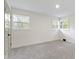 Bright bedroom with neutral carpet and two windows at 4475 Berkshire Rd, Indianapolis, IN 46226