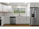 Modern kitchen featuring quartz countertops, stainless steel appliances, and white cabinetry at 4475 Berkshire Rd, Indianapolis, IN 46226