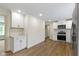 Modern kitchen featuring white cabinetry, stainless steel appliances, and vinyl flooring at 4475 Berkshire Rd, Indianapolis, IN 46226