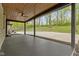 View of the covered patio leading to a backyard with an inground pool and mature landscaping at 4475 Berkshire Rd, Indianapolis, IN 46226