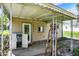 Outdoor back porch area with door, storage and ladder, offering a functional extension of the home at 4941 Mathews Ave, Indianapolis, IN 46227