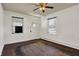 Bedroom featuring wood floors, a ceiling fan, two windows, and a closet at 4941 Mathews Ave, Indianapolis, IN 46227